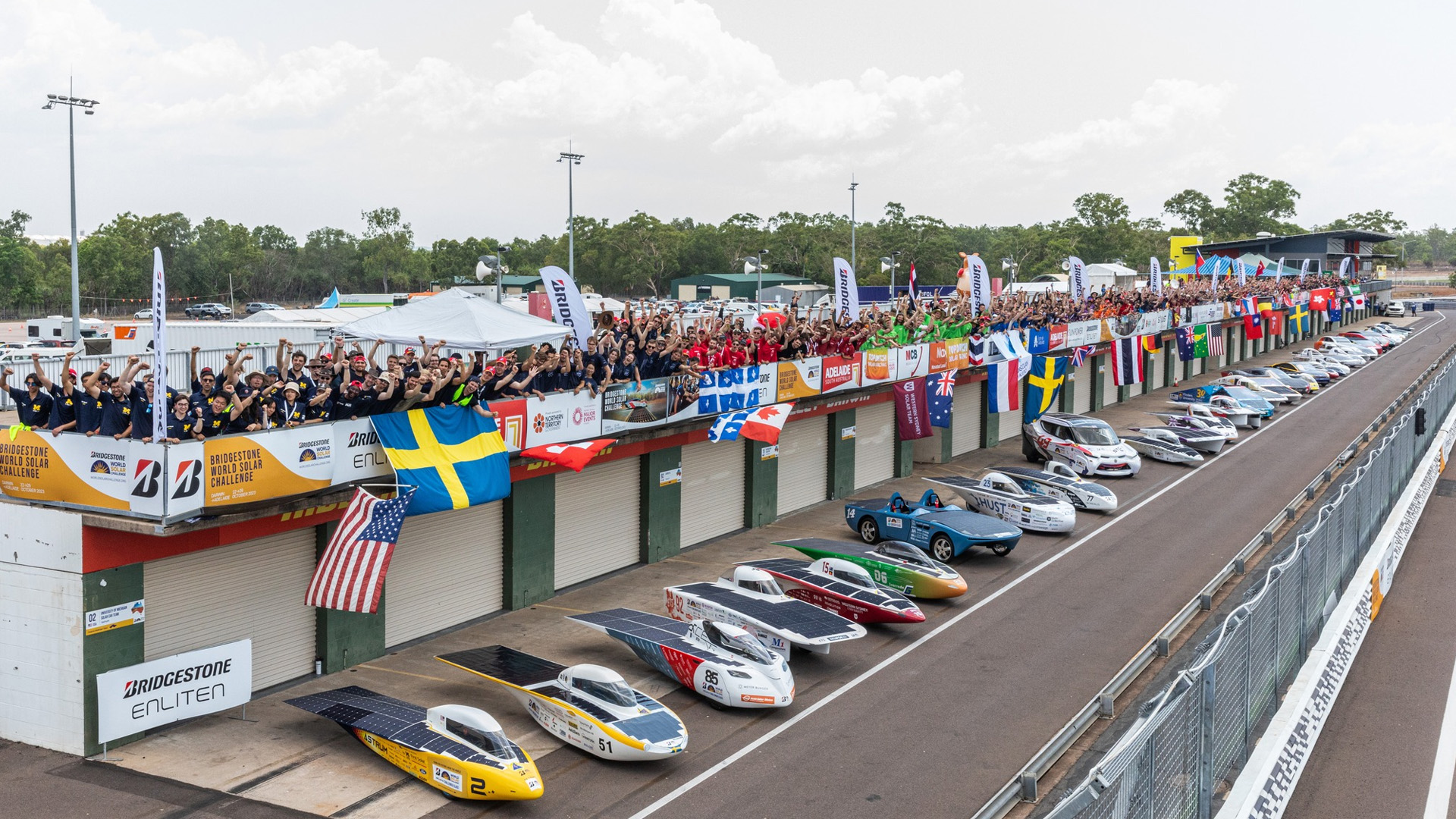 Participants from the 2023 World Solar Challenge with solar cars.