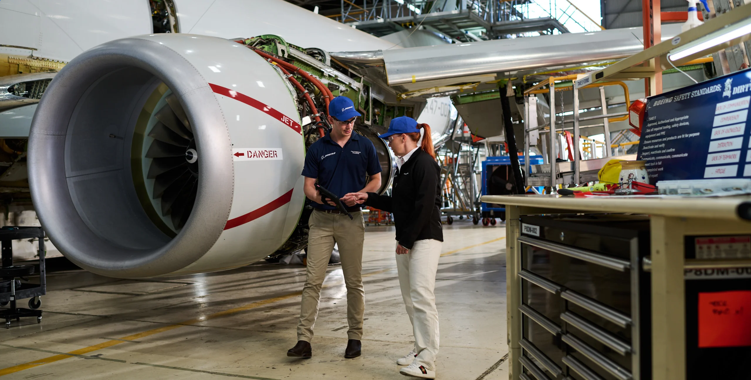 Aerospace Engineers in an aircraft maintenance hanger.