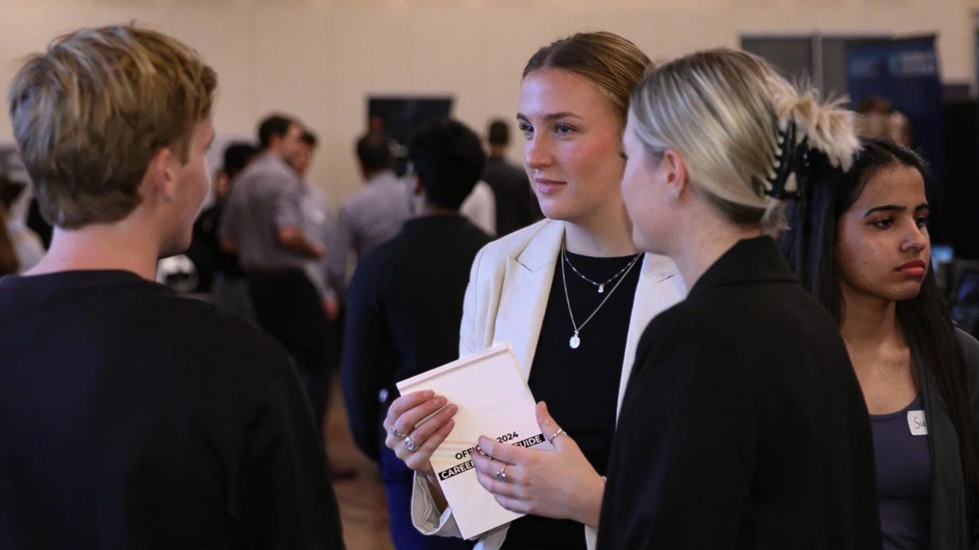 AUES Careers Night 2026 - A group of young women discuss the event in small group.