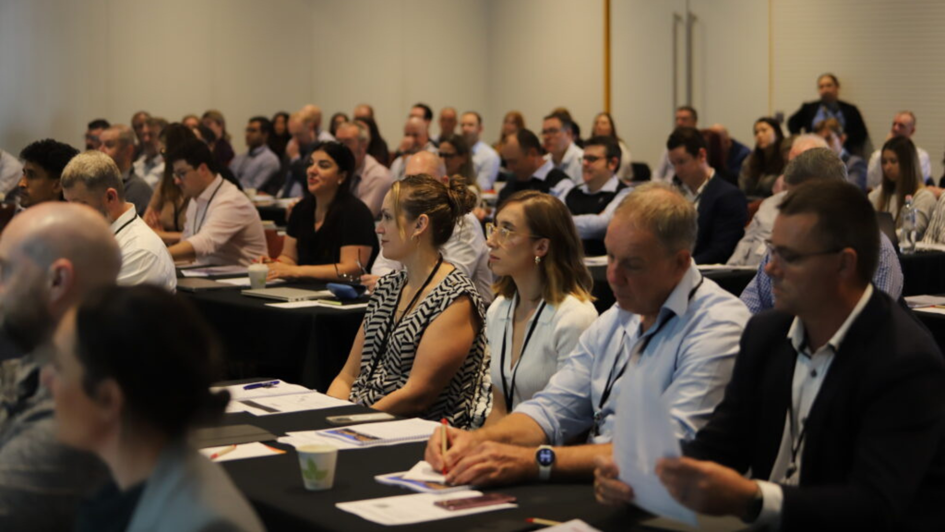 Defence Export Controls - a group of people gather to listen to a presenter